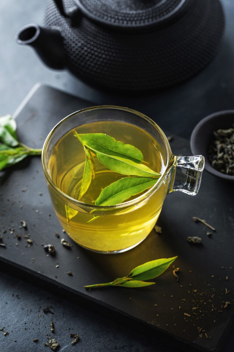 closeup-brewed-green-tea-cup-served-plate-table (1)